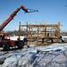 The first beam is lifted off the foundation as workers continue to dismantle a historic barn at Zingerman's Cornman Farms in Dexter on Monday, March 4, 2013. Melanie Maxwell I AnnArbor.com